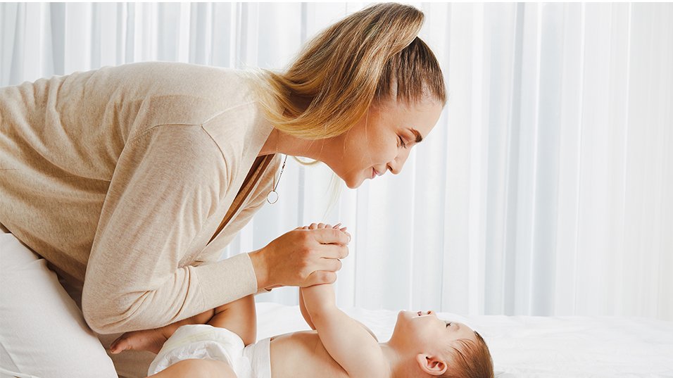 Women playing with baby